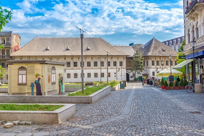 Bucharest one day tour with Parliament Palace and Village Museum - Panoramic drive stops: Cantacuzino, Ateneul Roman, and royal-era buildings